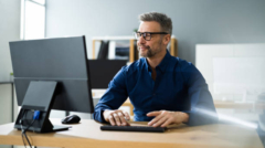 Businessman Using Business Computer In Office Or Workplace