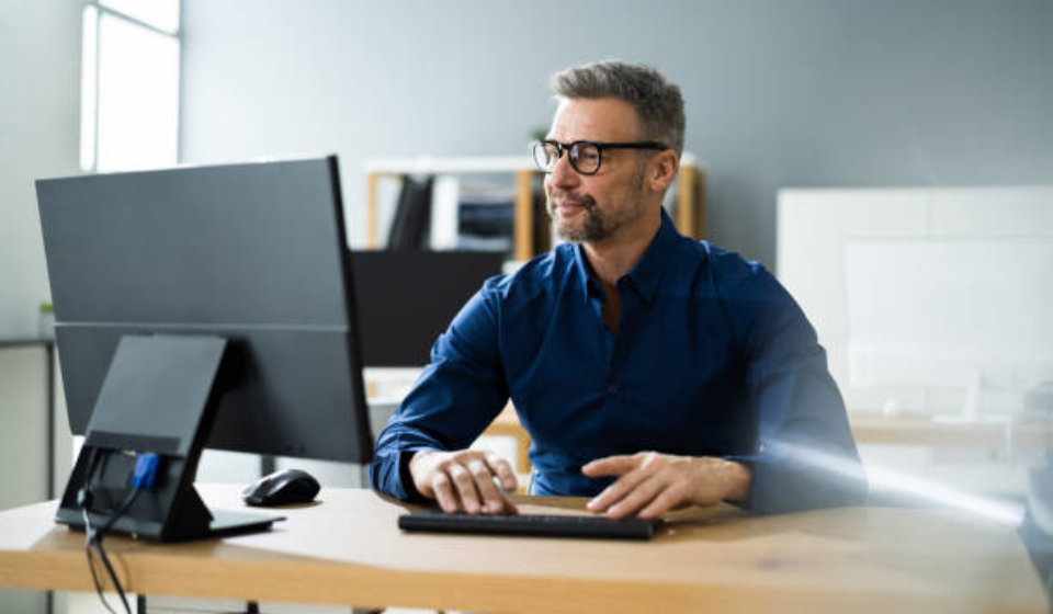 Businessman Using Business Computer In Office Or Workplace
